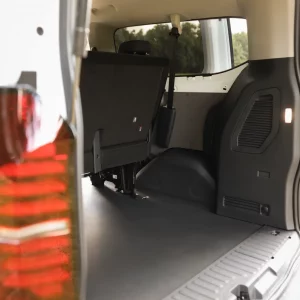 Offener Kofferraum eines VW 9-Sitzers mit hochgeklappter hinterer Sitzbank und sichtbarem Rücklicht